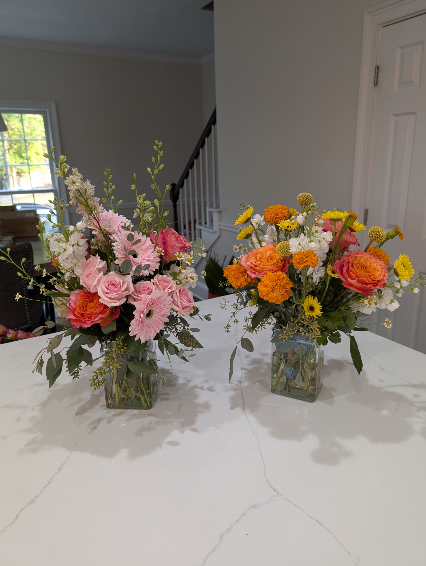 Pink and yellow floral centerpiece arrangements